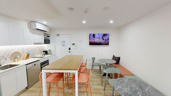 a kitchen and dining area with a wooden table and chairs