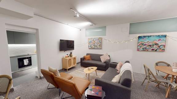 a living room with couches and a table and a television