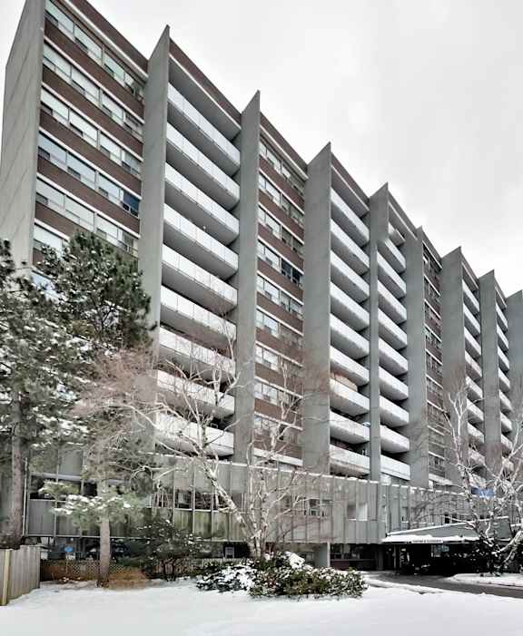 an apartment building covered in snow in the winter