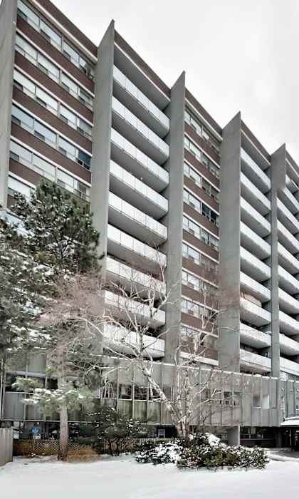 an apartment building covered in snow in the winter