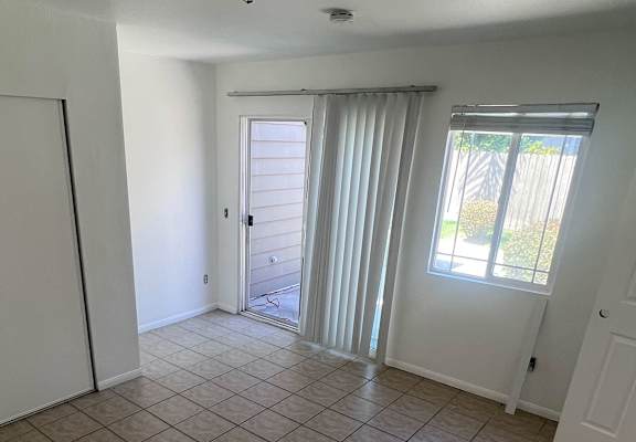 a bedroom with a wardrobe and a door to a patio