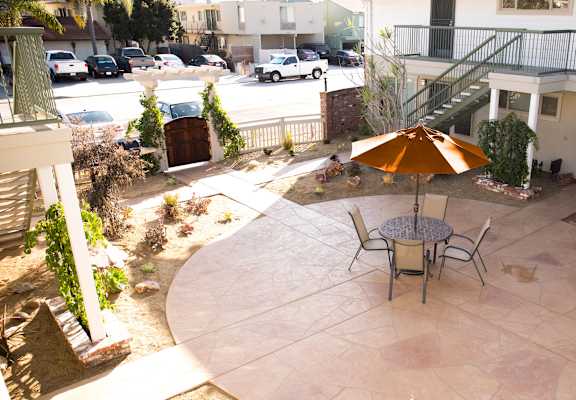 a patio with a table and chairs and an umbrella
