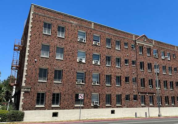 a red brick building with a blue sky in the background