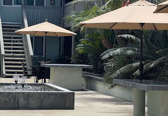 a courtyard with a fountain and stairs leading up to a building