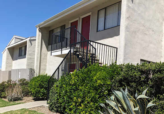 a building with a red door and a staircase