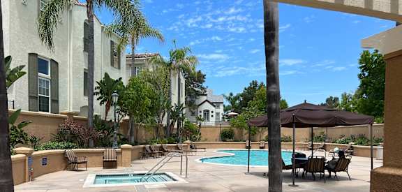 a pool and hot tub at the enclave at woodbridge apartments in sugar land, tx