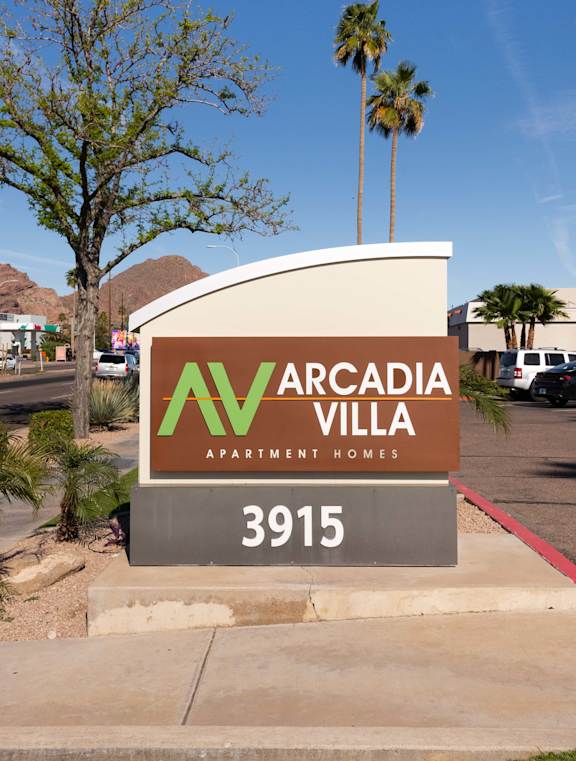 a sign apartment homes in front of a parking lot