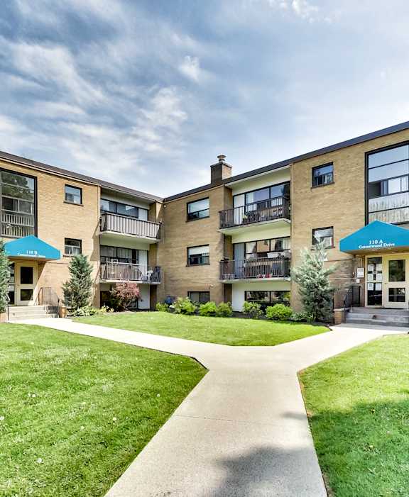A sunny day at a residential complex with a clear blue sky.