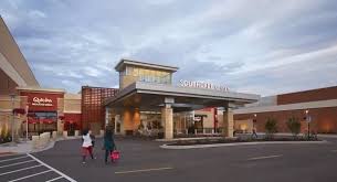 A shopping center with a QuikTrip store in the foreground.