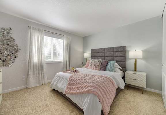 a bedroom with a bed and a window at The Legacy Apartments, California