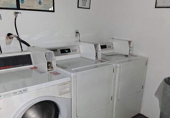 A washing machine with a control panel and a digital display.