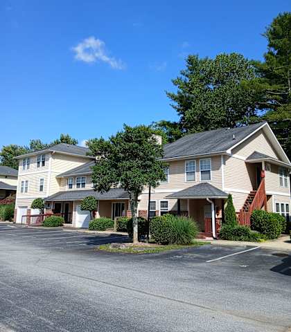 A row of houses with a clear blue sky above them.
