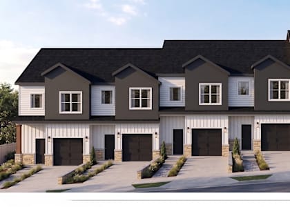 A row of houses with garages in front.