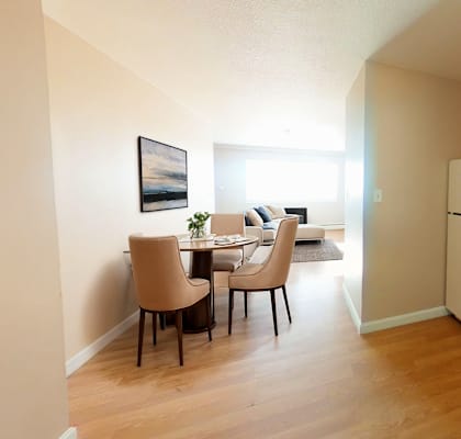 a kitchen and dining area with a refrigerator and a table