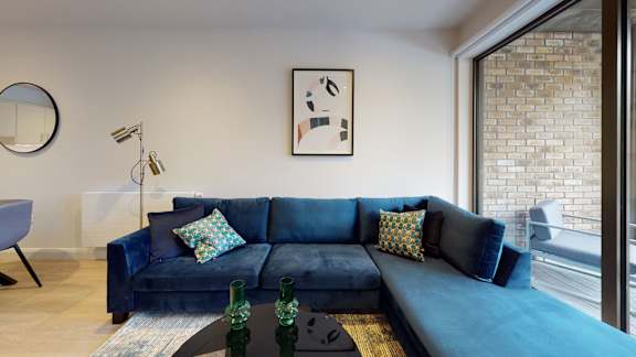 a living room with a blue couch and a coffee table