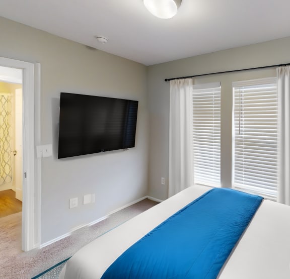 a bedroom with a bed and a ceiling fan