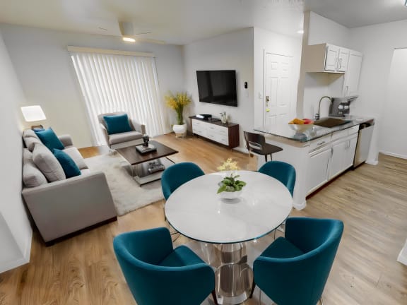 east austin apartments with wood floors and open concept floor plan with a couch, tv and dining table