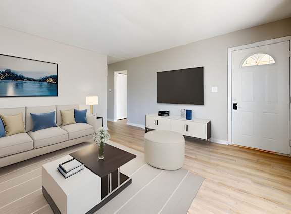 A living room with a couch, coffee table, and television.