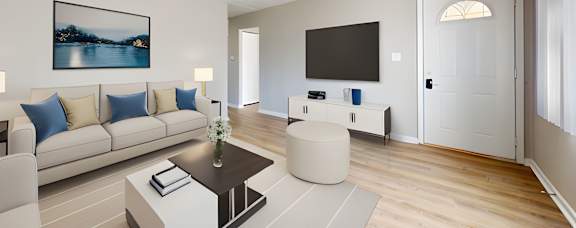 A living room with a couch, coffee table, and television.