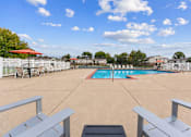 Thumbnail 3 of 6 - A pool surrounded by a white fence and a red umbrella.