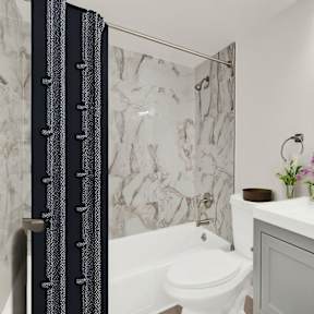 a bathroom with a shower and a sink and a toilet