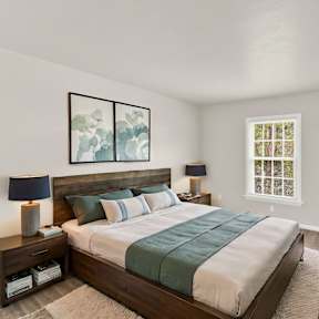 the master bedroom has a large bed and a tv