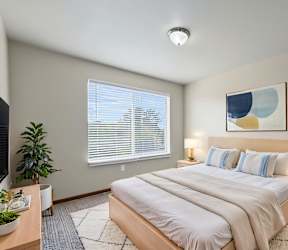 a bedroom with a bed and a ceiling fan at Melbourne Apartments, IA, 50320