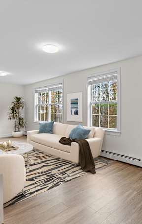 a living room with white walls and a white couch