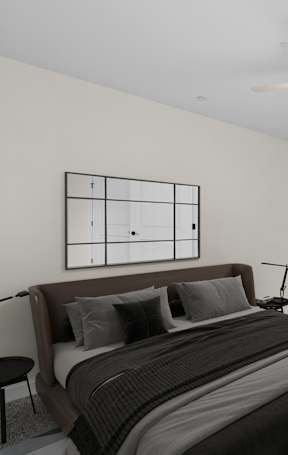 A bedroom with a large bed and a ceiling fan.