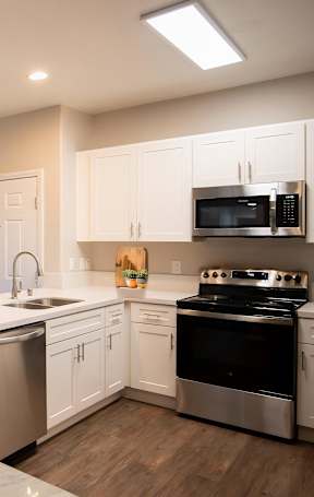 A modern kitchen with a dining table and chairs.