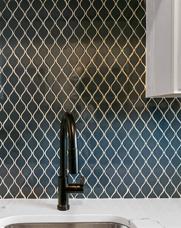 A kitchen sink with a black faucet and a tile backsplash. at The Park on 13 Apartments - Royal Oak, MI Apartments, Royal Oak, MI, 48073