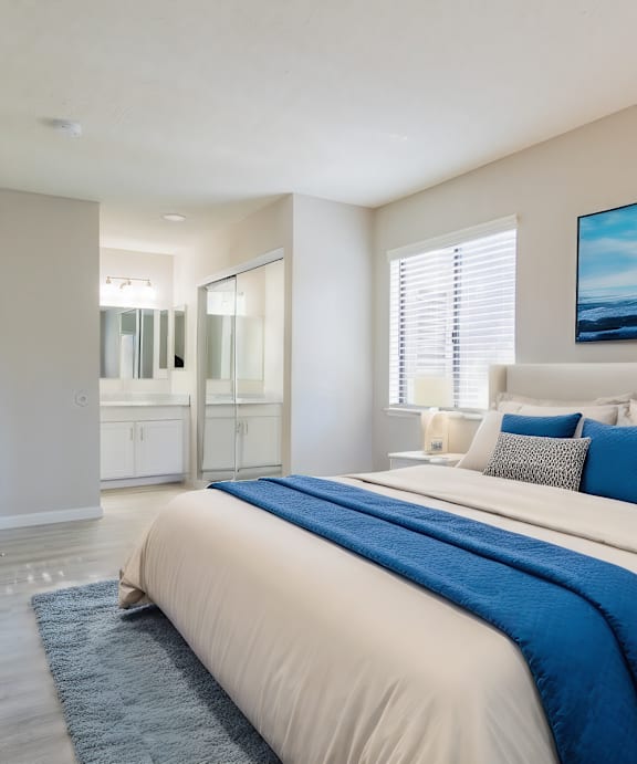 a bedroom with a large bed and a bathroom