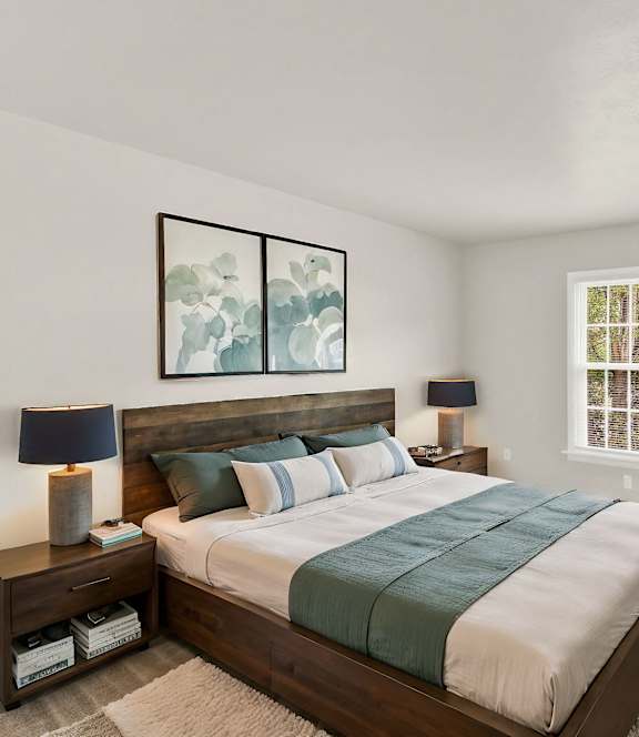 the master bedroom has a large bed and a tv