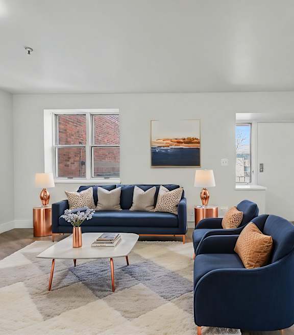 A living room with a blue couch and a coffee table.