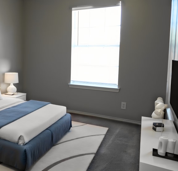 a blue and white bedroom with a bed and a window