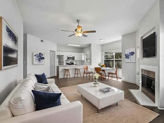 A living room with a white couch and a coffee table.
