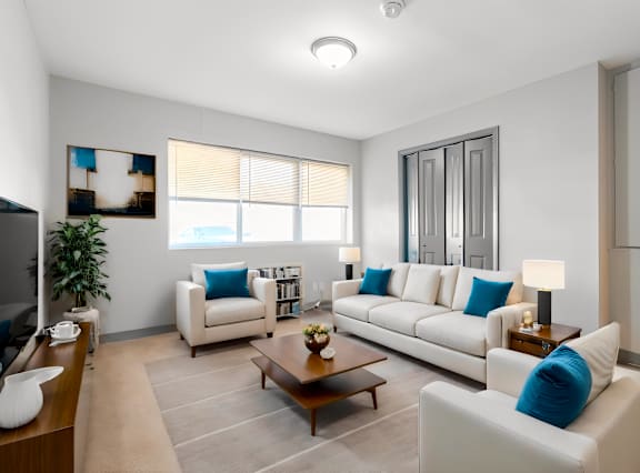 a living room with couches and chairs and a table