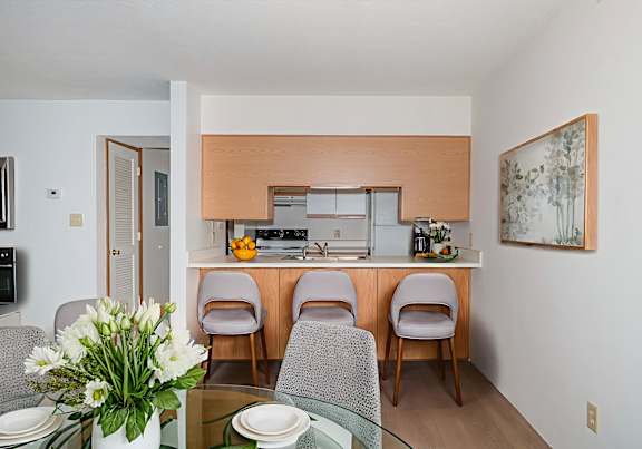 a dining room and kitchen with a table and chairs