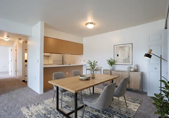 a dining room and kitchen with a table and chairs