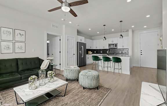 A modern living room with a green sofa and a coffee table.