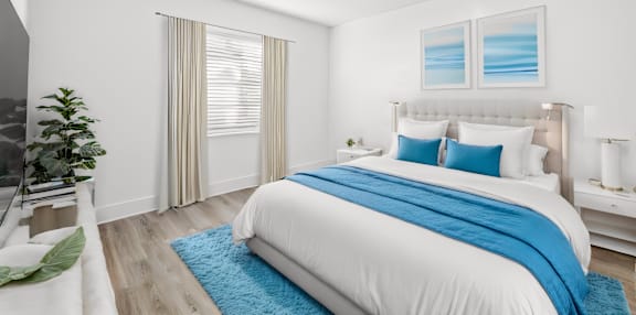 A bedroom with a large bed and a TV on the side.