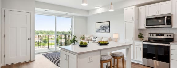 an open kitchen with a large island with two stools