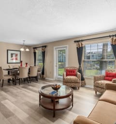 a living room with couches and chairs and a dining room table at Oak Reserve at Winter Park, Florida, 32792