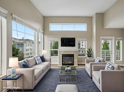 A living room with a fireplace and a television.