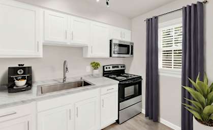 a kitchen with white cabinetry and black appliances and a window