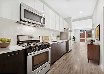A modern kitchen with a stove, oven, and microwave.