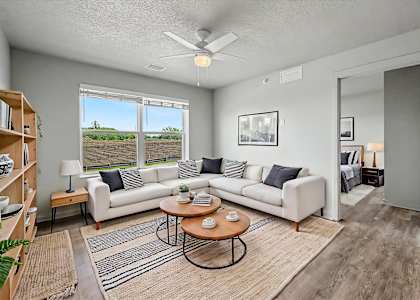 A living room with a white couch and a coffee table.