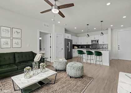 A modern living room with a green sofa and a coffee table.