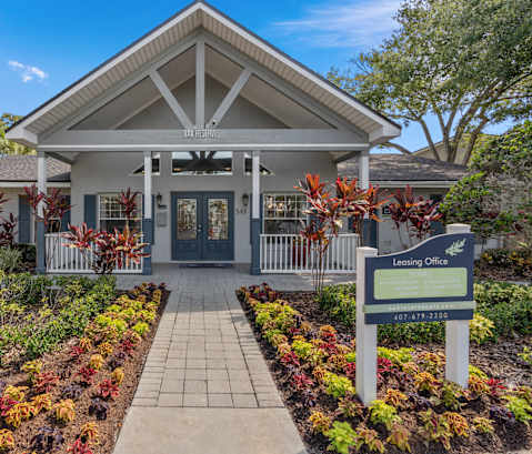 the entrance to a building with a sign in front of it at Oak Reserve at Winter Park, Winter Park