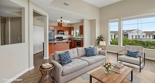 A living room with a grey couch and a coffee table.